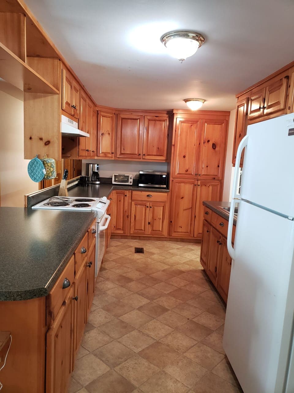 Large kitchen with Coffee Maker, microwave, pans, bowls, and more!