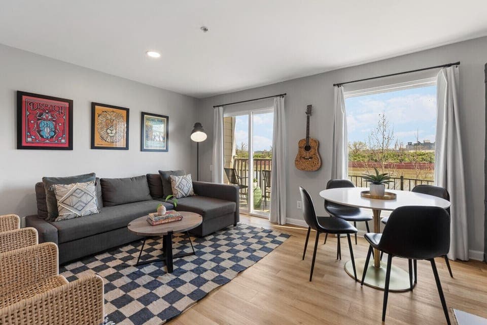 Living room with pullout sofa, dining table for 4, electric fireplace plus private patio overlooking the river!