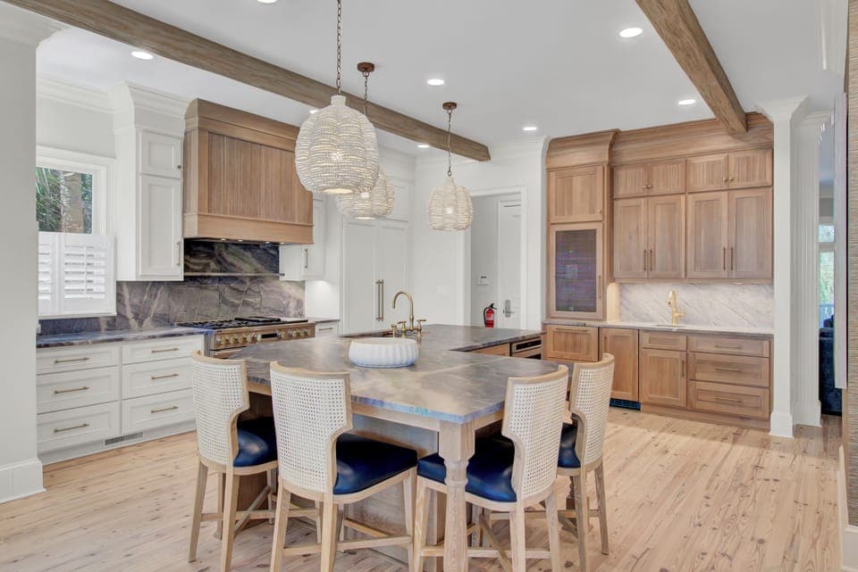Kitchen features an island and a counter with barstool seating.