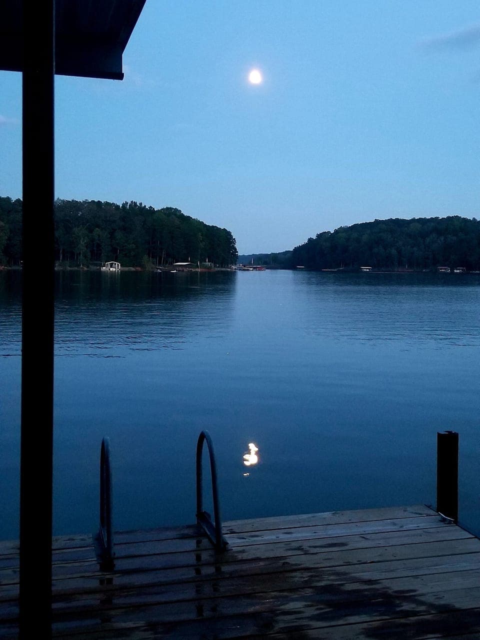 Bright full moon rising on the lake - early fall. Water is still good for swim.