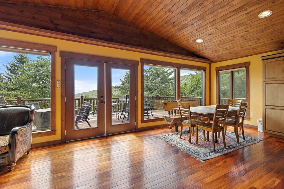Tongue-and-Groove Ceilings and Wood Floors with Wall of Windows