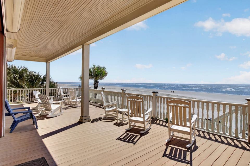 Your private oceanfront balcony awaits with rocking chairs for watching waves and endless blue horizons.