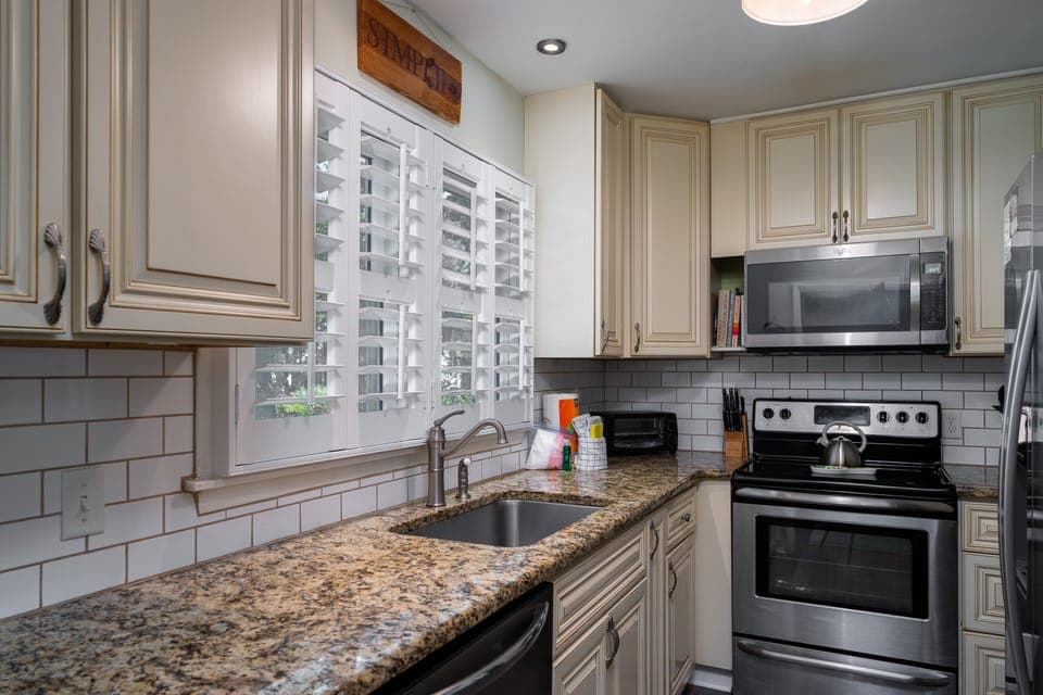 The kitchen has been updated with granite counters and custom cabinets.
