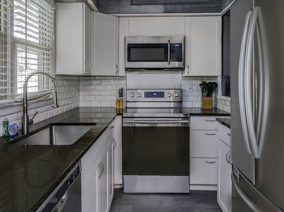 New counter tops, painted cabinets and appliances in the kitchen.