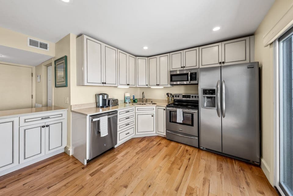 Highlights include custom cabinets, stainless appliances & access to the deck.