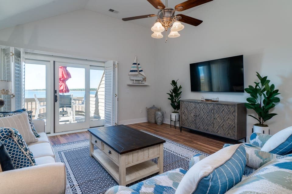 This villa has plenty of natural sunlight. Sliders lead out to the rear deck with spectacular views of the water and the beach. Steps away from the beach