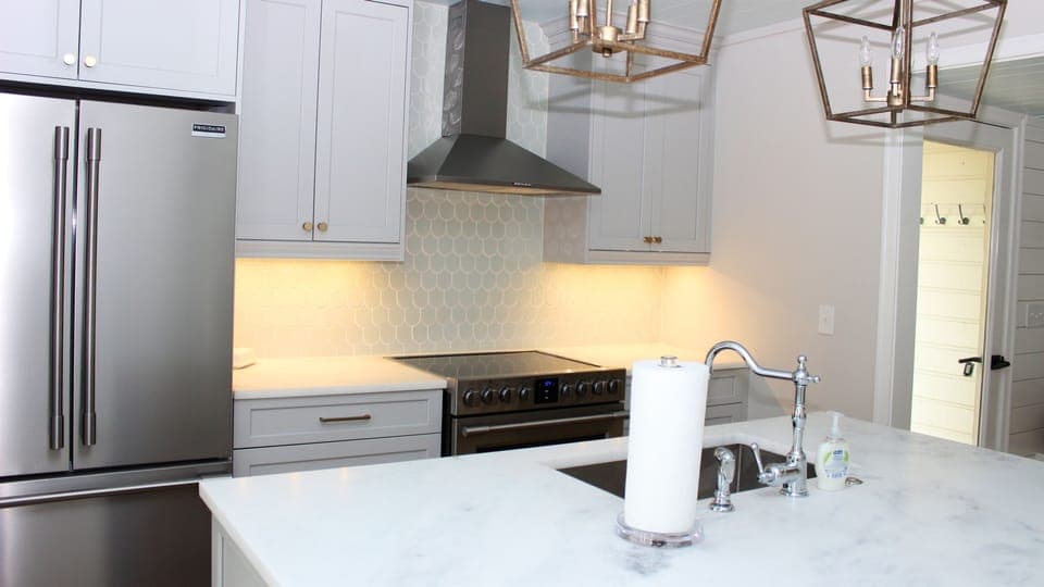 Features include new appliances, beautiful honed marble counters, and a soft green tile.