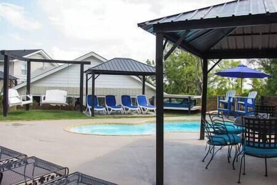 Outdoor Pool Area with Swings and covered Seating