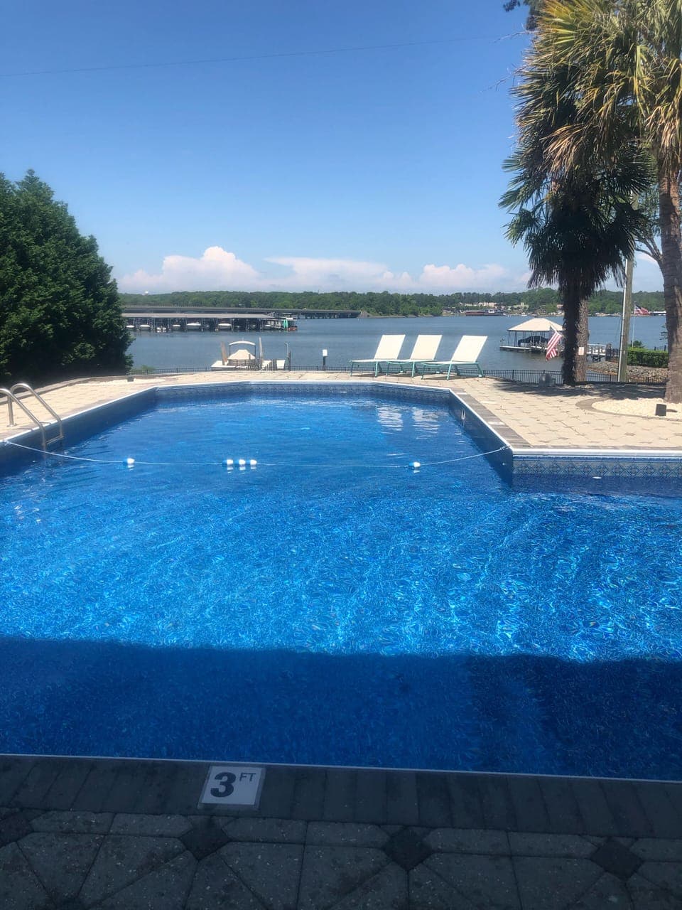 large pool with lake view, in pool volleyball net