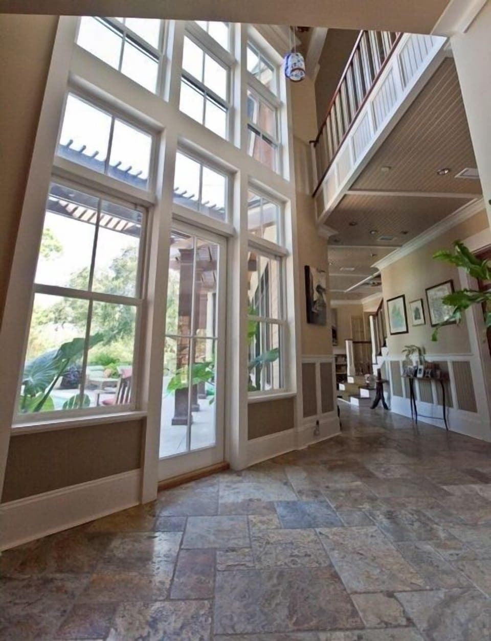 Foyer area and french doors to back deck pool and BBQ area.
