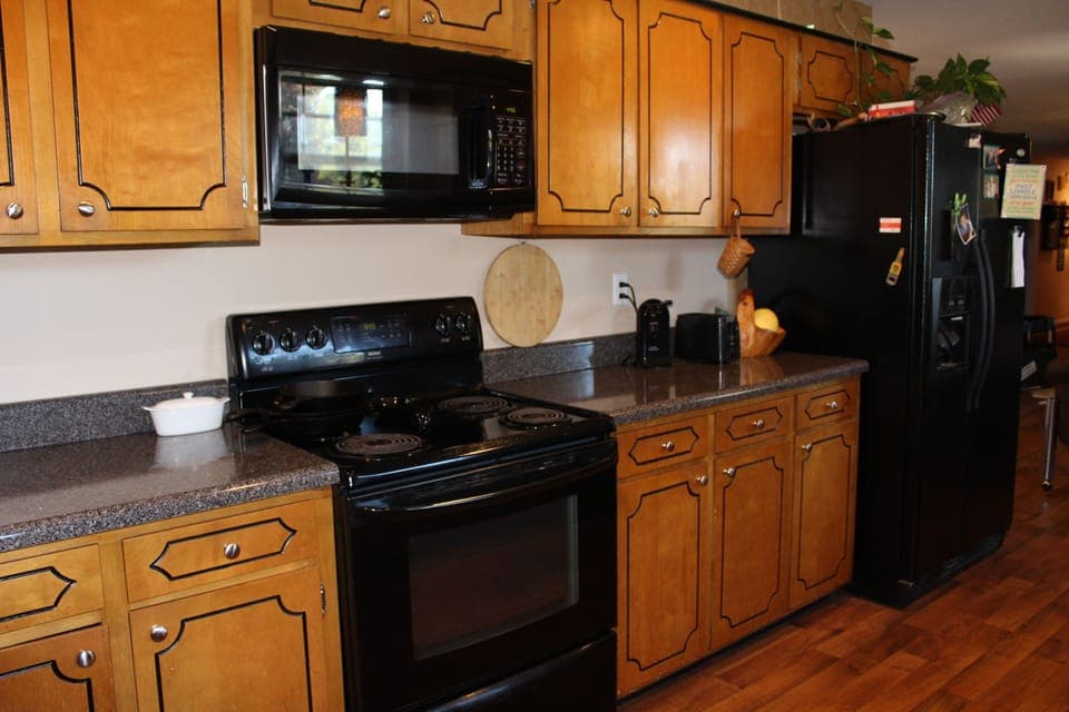 Kitchen with lots of counter space, microwave and side by side refrigerator 