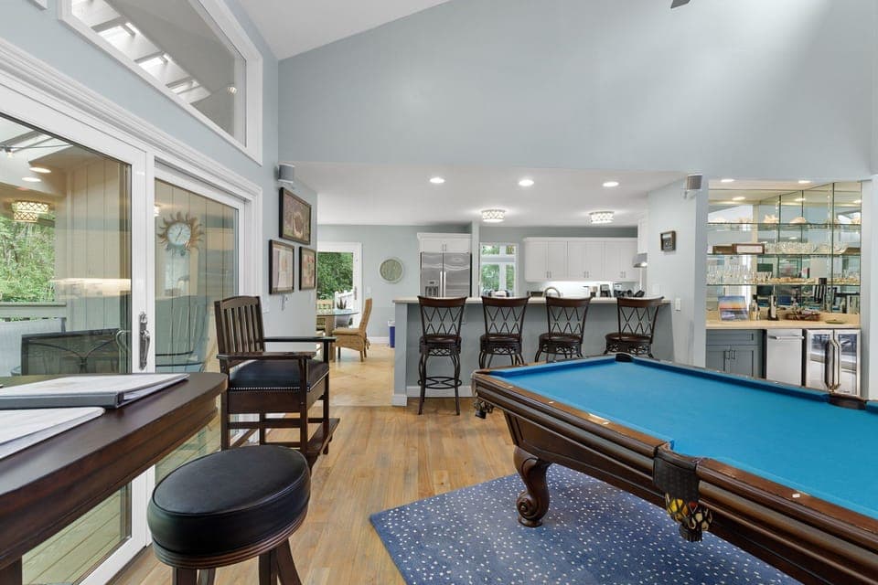 The billiard room has a full sized pool table & a 65" 4K TV along with a wet bar with ice maker & wine fridge. Great space to watch a game while playing a game of pool.