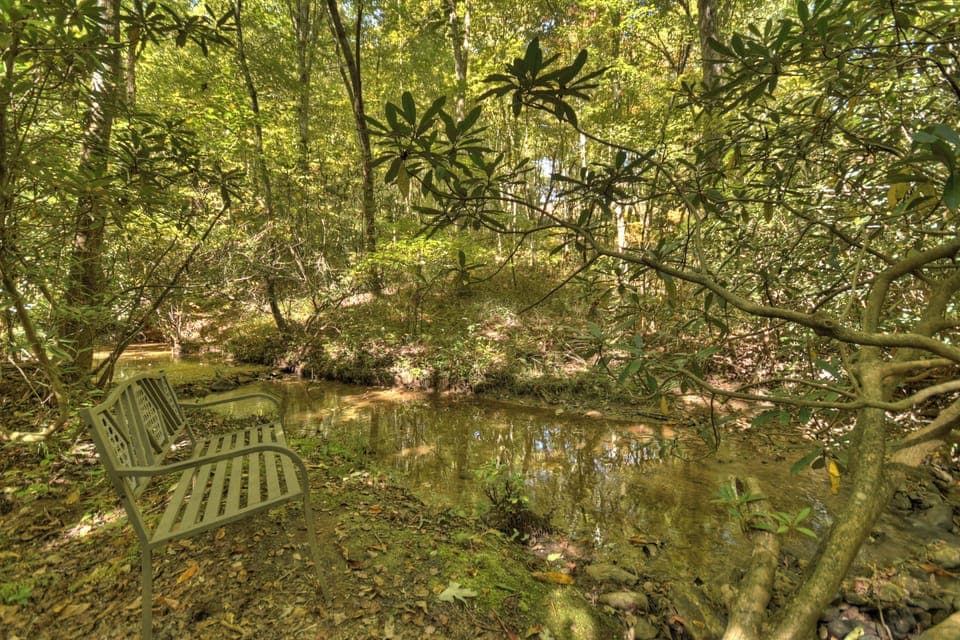 Adirondack chairs by the creek