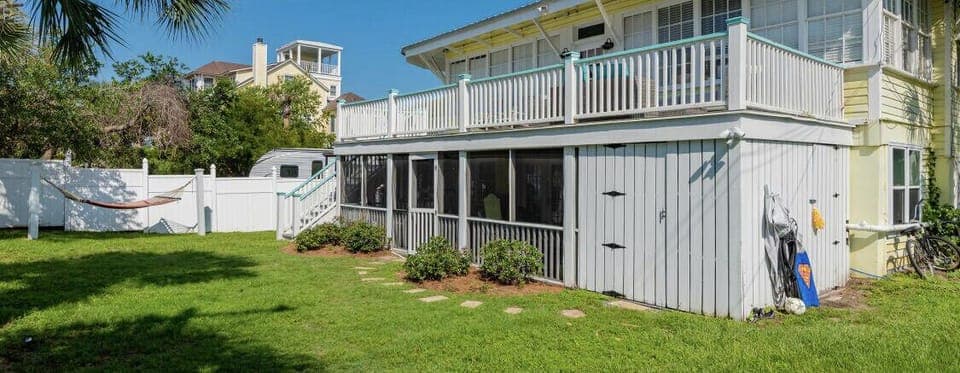 outdoor shower, fenced in yard, hammock, closet with beach chairs, & beach games