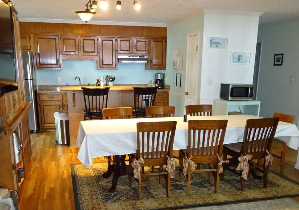 Dining table seats 6-8; seats at bar &more at side table beneath stairs 