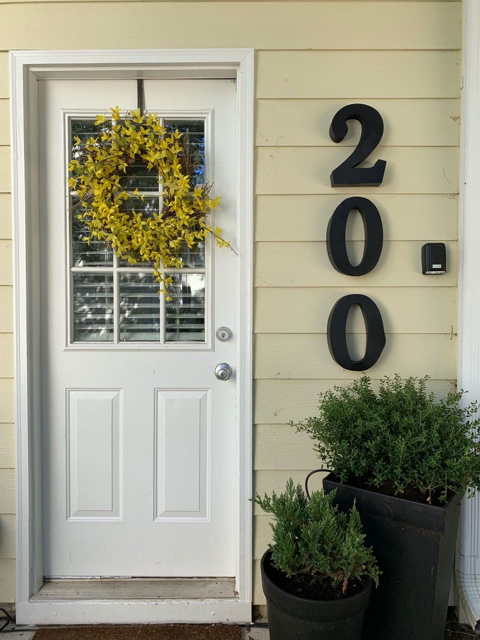 Back door with lock box. Just steps away from our other 2 units, #300 and #301 
