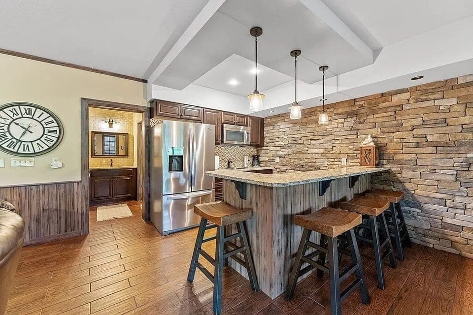 Lower level kitchenette with second full refrigerator, microwave, and sink