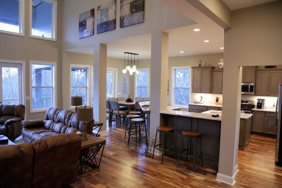 Living, kitchen and dining areas with vaulted ceiling.