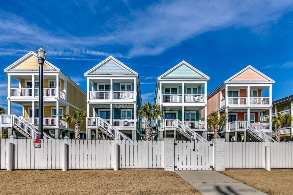 4 villas on corner lot; share huge pool within white gate.
