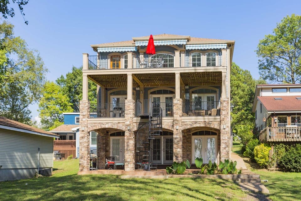 Back of the house facing the lake and large flat yard