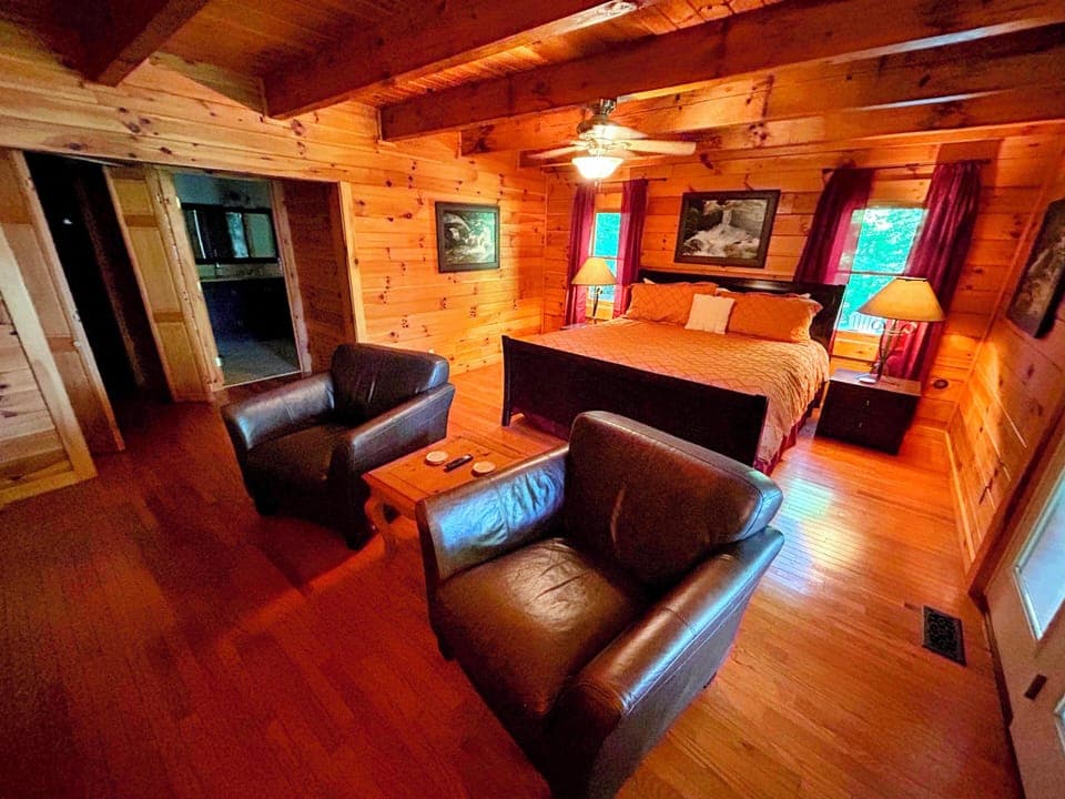 king bed. sitting area. door to outside. bathroom. oversized walk in closet.