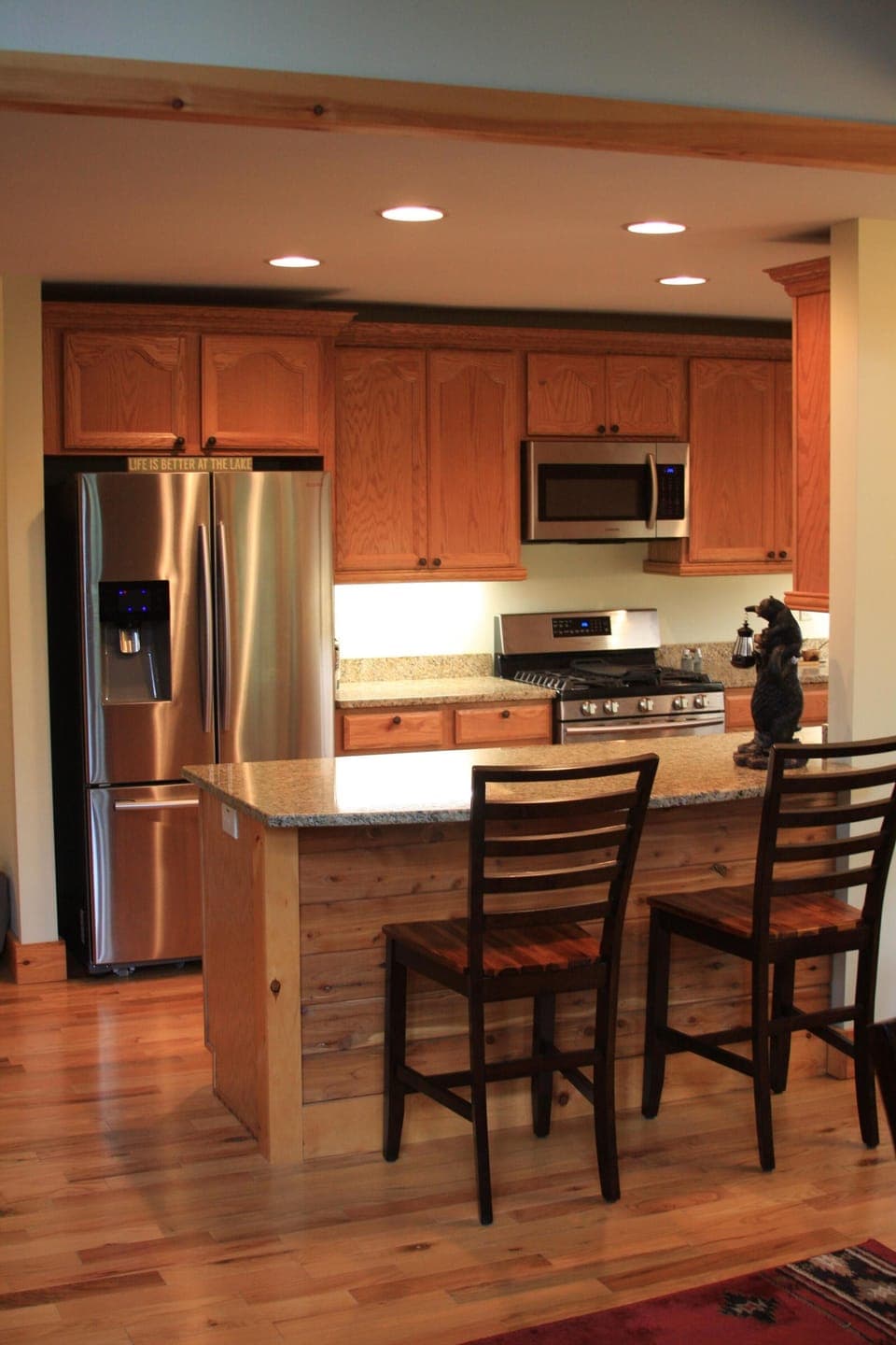 View of kitchen with Refrigerator, oven, Microwave