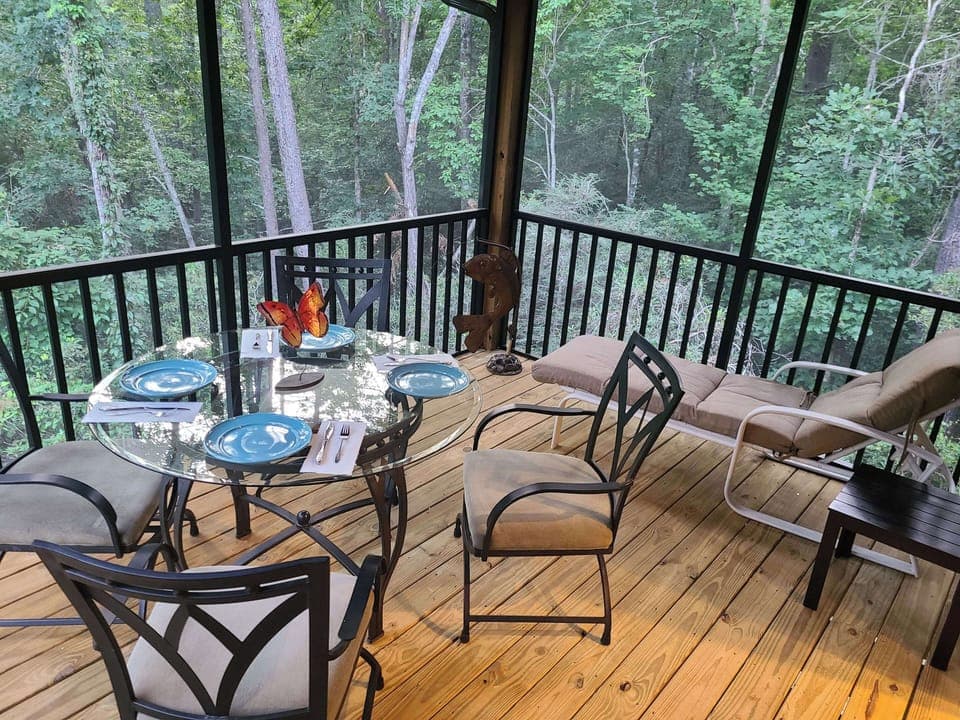 Screened porch next to kitchen overlooking woods listening to babbling stream