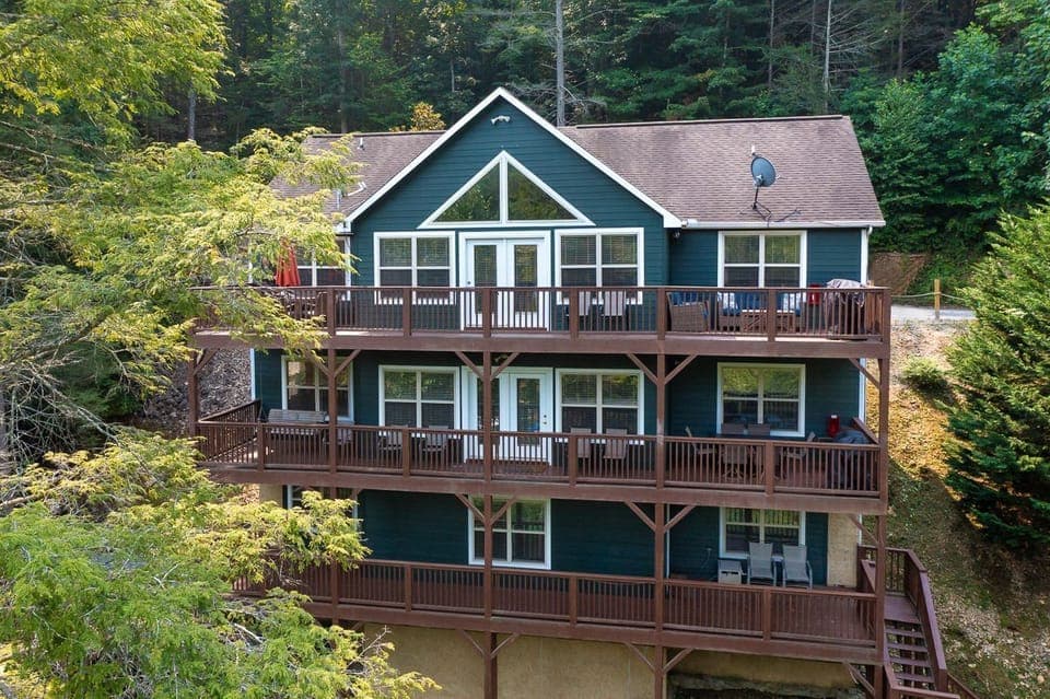View of the Back of the house from lake side. 3 full decks. 2 grills. Hot Tub. 
