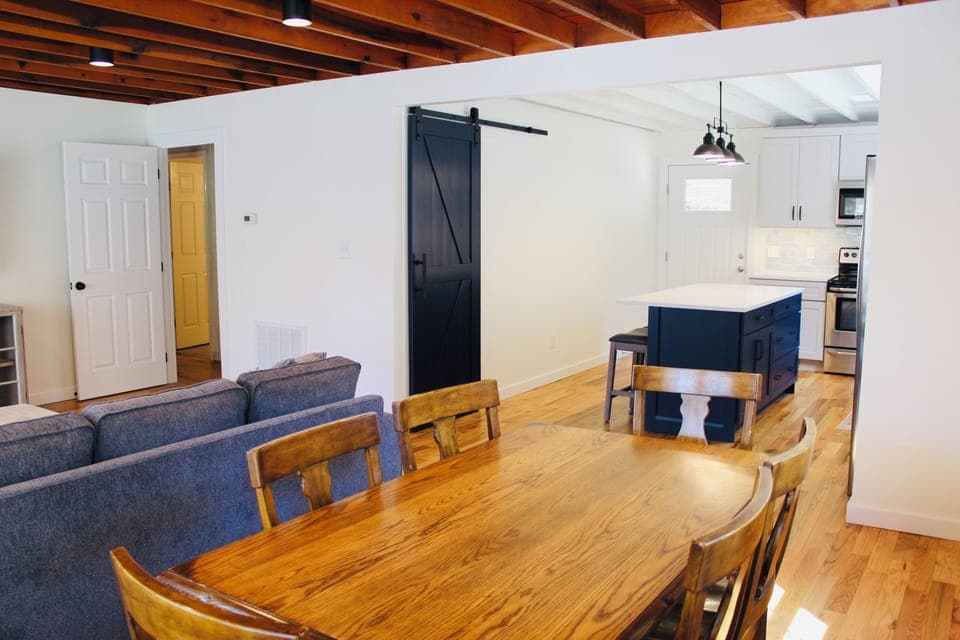 Exposed cedar beam ceilings with large open floor plan. Barn door into pantry.