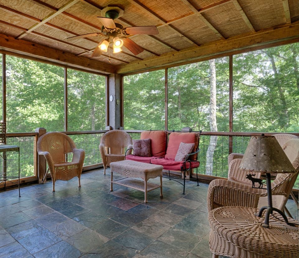 Screened porch, main floor level but ends up in the trees at this end of house.