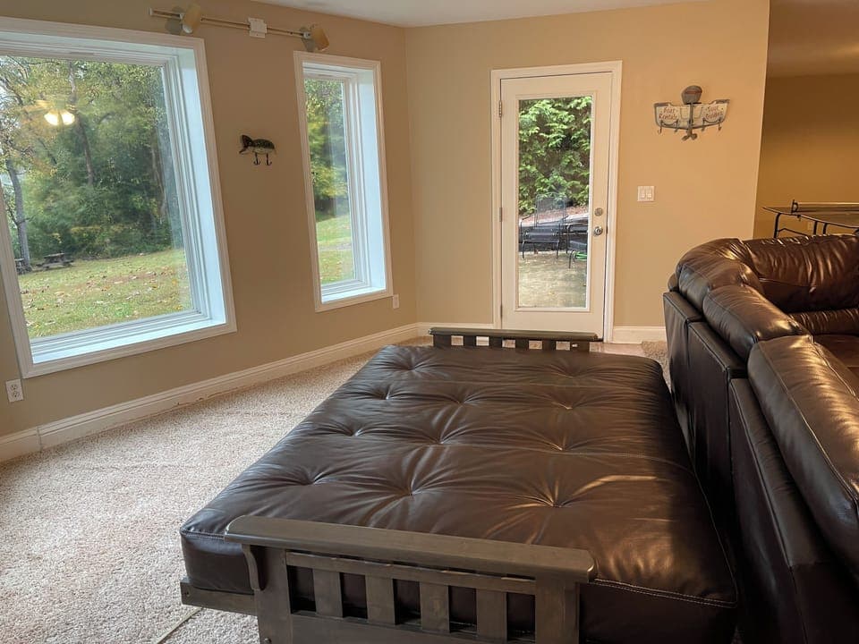 Futon bed/couch in downstairs living room. 