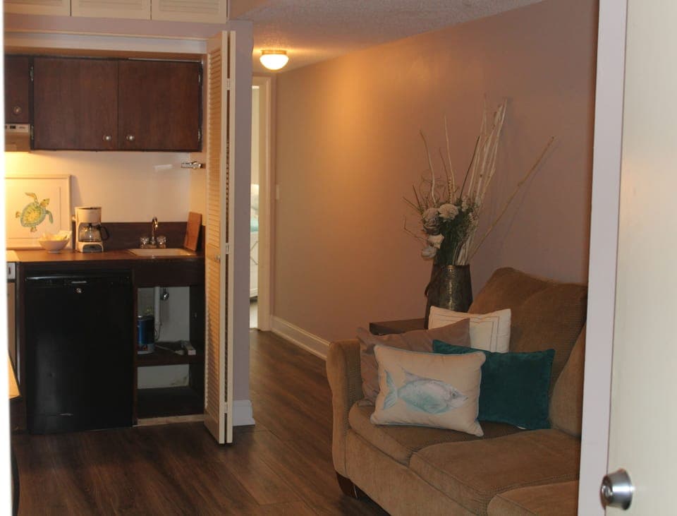 Den area with Kitchenette frig  coffee maker and stove