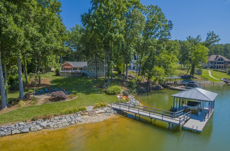 Aerial lake view of  backyard, dock and shoreline