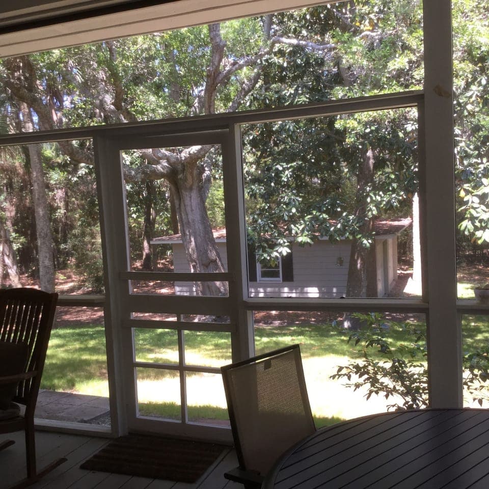 View of the private back yard and garage from the large rear porch.