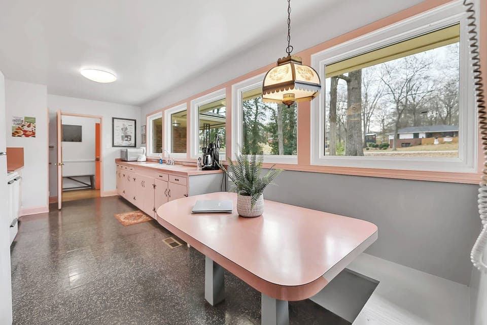 Kitchen is 21 feet long with its original light fixture over the banquette. 