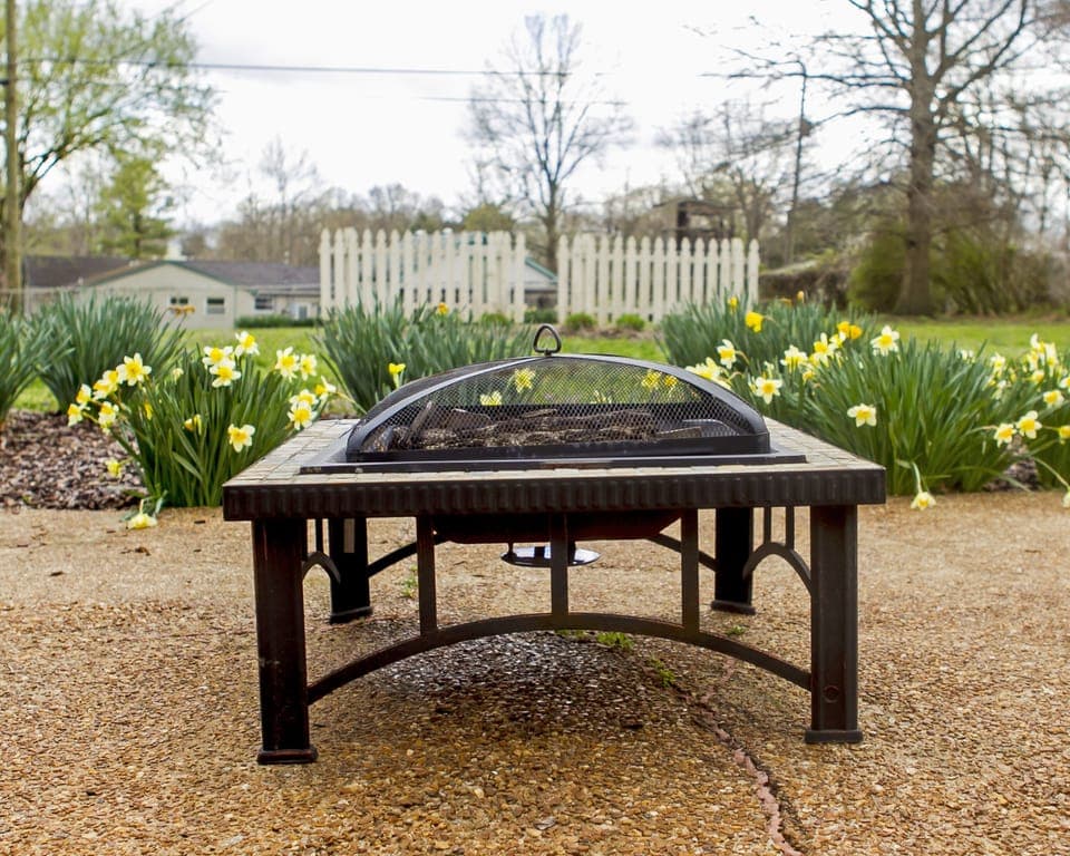Inviting large backyard with fire pit. 