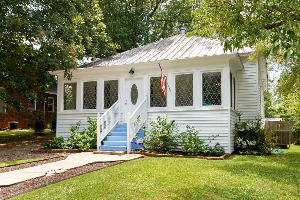 Front elevation of sleeping porch and leaded glass windows facing street.