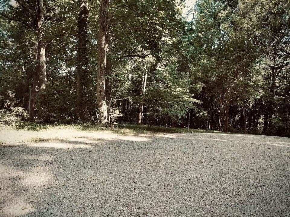 Gravel driveway and wooded charm provide peaceful surroundings and easy access.