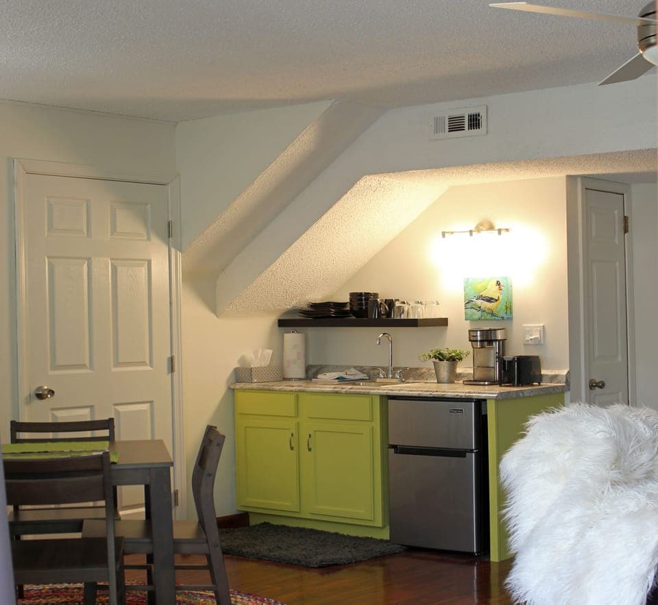 Kitchenette with sink, microwave, coffeemaker, toaster, and fridge.