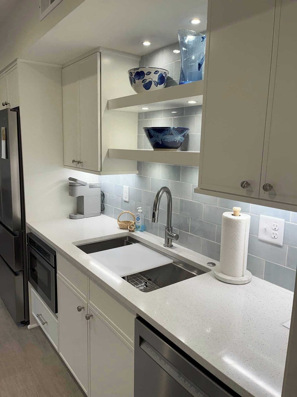 Bright, light kitchen with granite and workstation sink