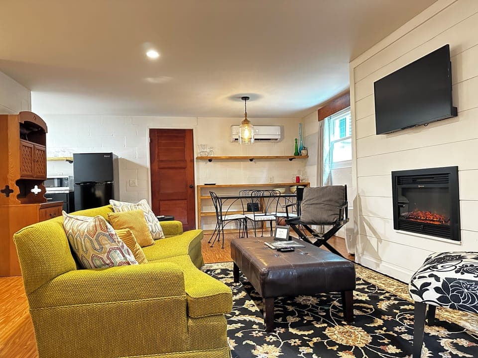 Living room c/w an electric fireplace and smart TV. 