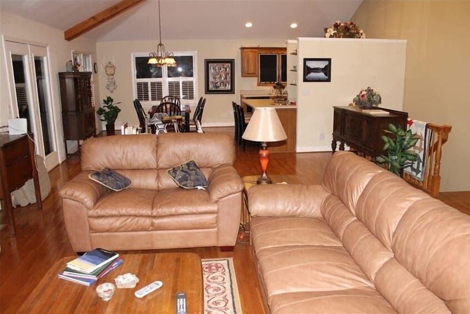 Leather sofas in living room, open living space to dining area & kitchen