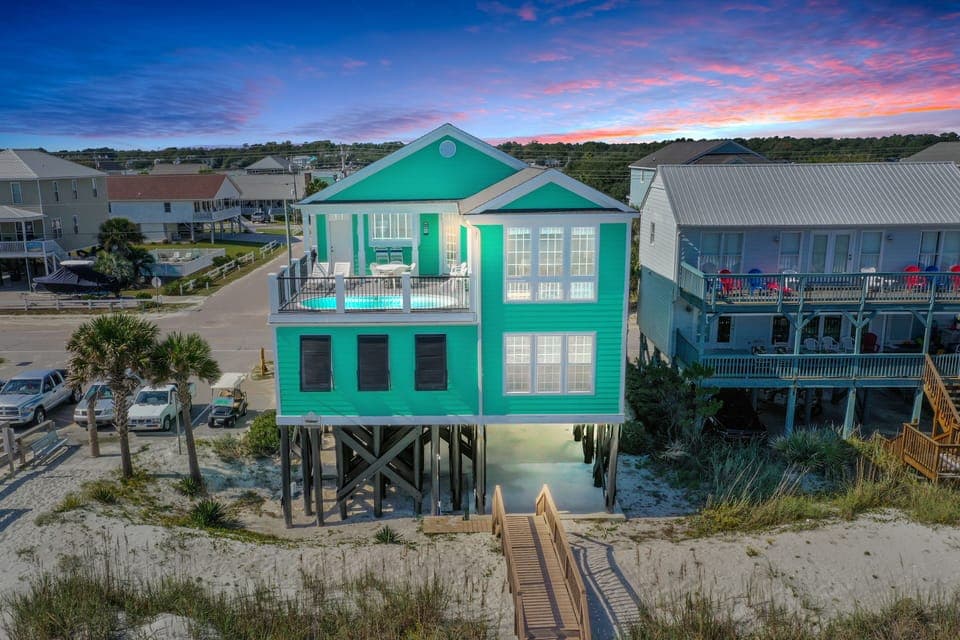 Vibrant beachfront property featuring stunning sunset views and direct beach access in a charming coastal neighborhood.
