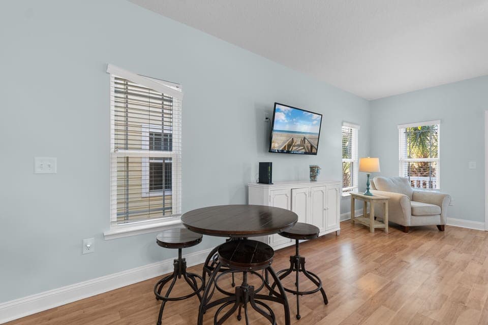Relax in your bright living space with comfortable seating, entertainment center, and charming dining nook for memorable meals together.