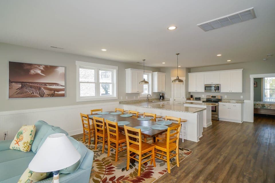 Your spacious open-plan living area flows seamlessly from cozy lounge to dining table and fully-equipped kitchen, perfect for family gatherings.