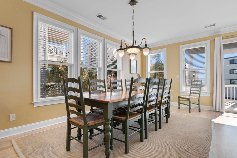 Gather around your elegant dining table with tropical palm views through large windows, perfect for family meals and memorable conversations.