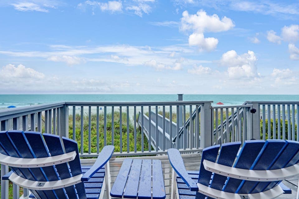 Relax in these charming blue chairs on your private deck, where ocean breezes and stunning sea views create the perfect coastal retreat.