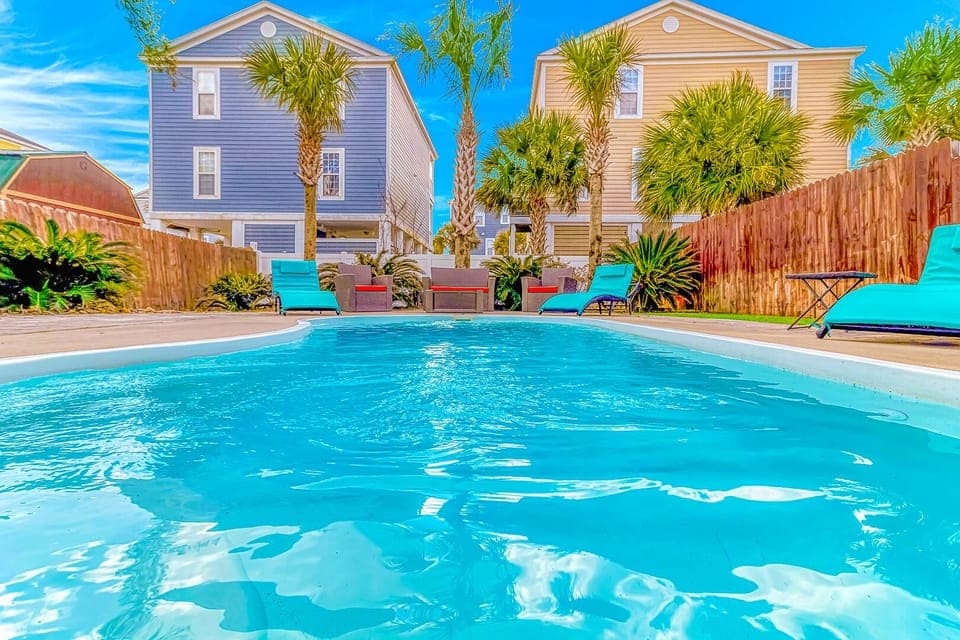 Dive into your private tropical oasis surrounded by swaying palms and vibrant beach houses under endless blue skies.