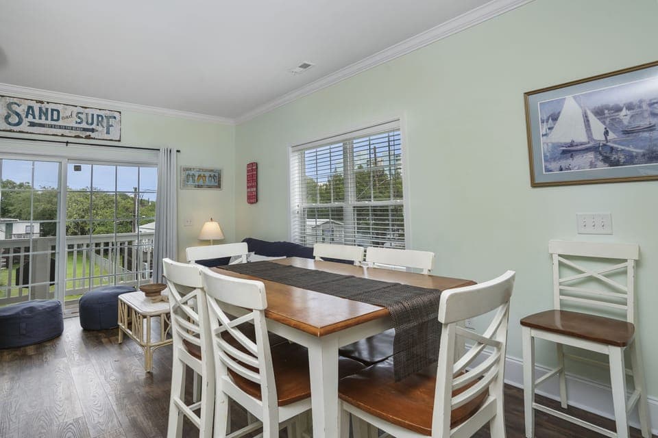 Gather around your spacious dining table for memorable meals, with nautical charm and natural light streaming through windows.