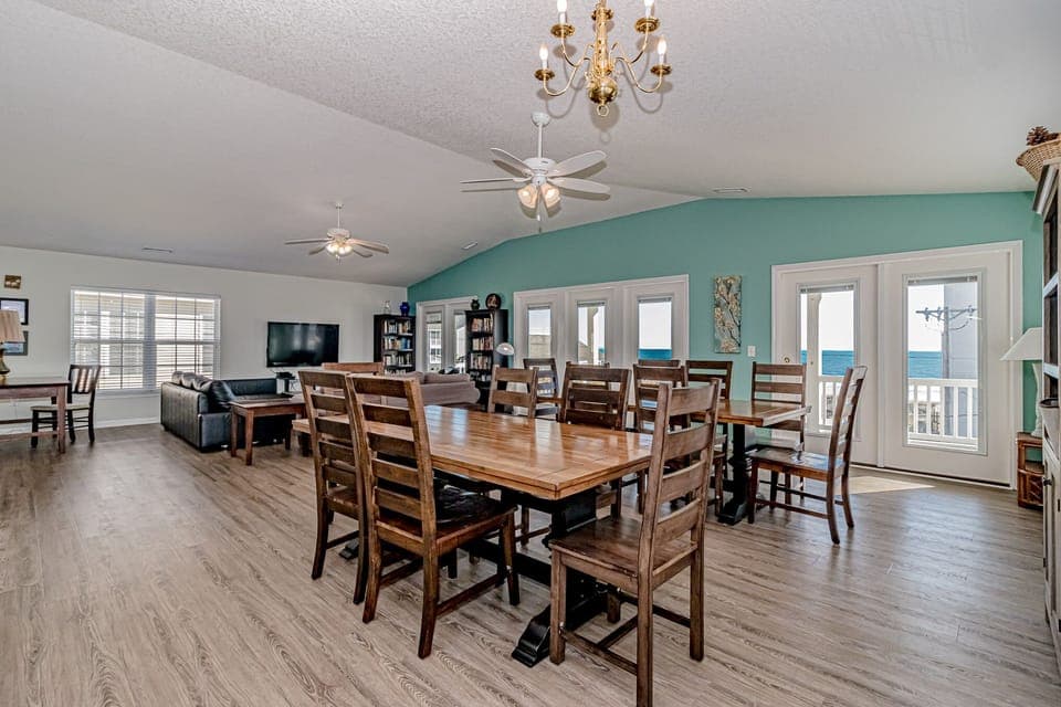 Gather your group around the spacious dining table while enjoying the coastal breeze from your private balcony doors.